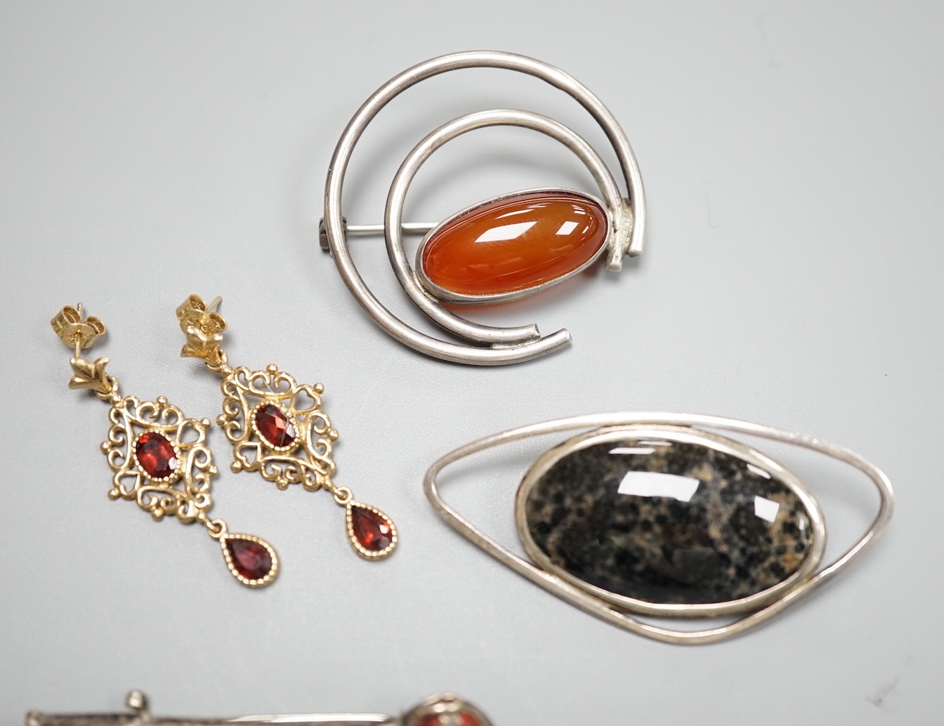 A modern pair of 9ct and gem set drop earrings and three white metal gem set brooches, including one silver and one set with Scottish hardstones.